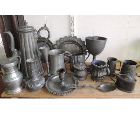 A selection of pewter wares to include, a tall coffee pot with applied scrolling handle and hinged finial lid with vertical r