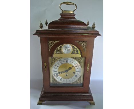 A mid-20th century German bracket clock in the 18th century style, the mahogany case enclosing a broken arch brass dial with 