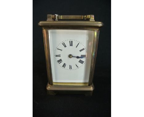 A French carriage clock with brass casework, enamel dial and 8 day timepiece.