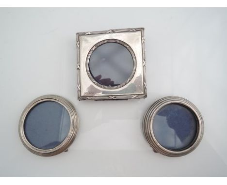 An Edwardian silver easel back picture frame, Henry Matthews, Birmingham, 1905, the square body with reed and ribbon borders,