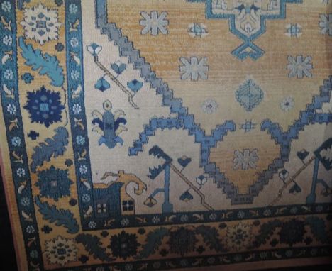 A wool work carpet in the Persian manner with ochre ground, geometric detail, set within running borders, 235 x 160 cm