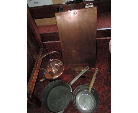 A graduated set of four Victorian zinc lined copper domestic saucepans, each with applied ironwork handles together with a su