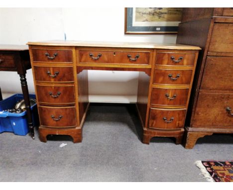 Reproduction walnut twin pedestal desk, shaped rectangular top with leather inset, nine drawers, bracket feet, 120x60cm, heig