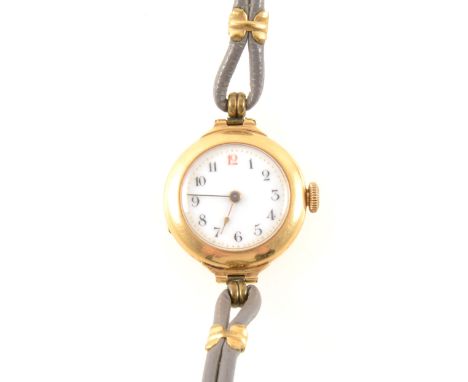 A lady's 18 carat yellow gold wrist watch, circular white enamel arabic dial in an 18 carat yellow gold 25mm plain polished c