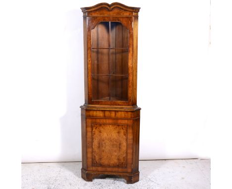 Reproduction walnut freestanding corner cabinet, shaped cornice, glazed door above a cupboard, bracket feet, width 66cm, heig