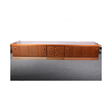 A Hulsta teak low-line sideboard, fitted with drawers and cupboards, length 243cm; and a matching two door cabinet, width 103