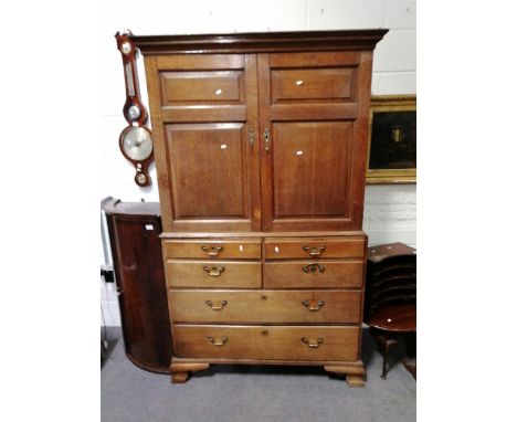 George III Country made oak press, moulded cornice, two fielded panel doors to the upper section, four short and two long dra