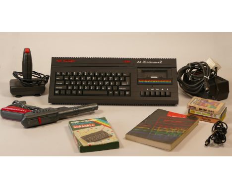 Sinclair Spectrum +2A (black version) with user manual, defender light phaser, spectrum joystick, collection of twenty games 