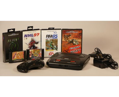 Sega MegaDrive II console with, power supply unit, controller pad, TV lead with RF unit and a selection of six games includin