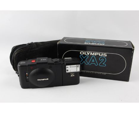 Olympus XA 2 Compact Film Camera w/ A11 Flash &amp; Original Box  This camera is WORKING and in a good condition Tested with 