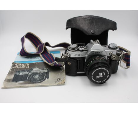 Canon AE-1 SLR Film Camera Canon FD 50mm F/1.8 Lens w/ Case &amp; Instructions  The camera is WORKING and in a vintage condit