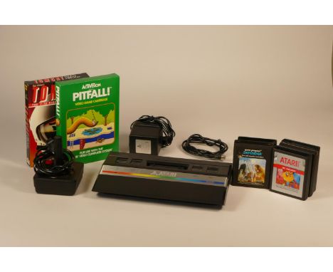 Boxed Atari 2600 complete with power supply, joystick controller, tv lead, owners manual. Including seven games- TomCat, Ms. 