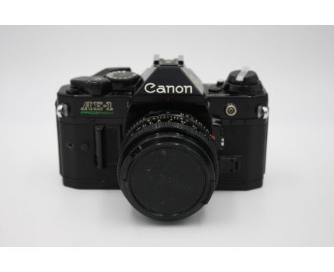 Canon AE-1 Program SLR Film Camera (All Black) w/ Canon FD 50mm F/1.8 Lens  The camera is WORKING and in a good condition Win