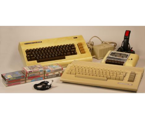 Commodore VIC 20 together with a Commodore 64 with joystick, cassette player, power supply, TV lead and a selection of ten ga
