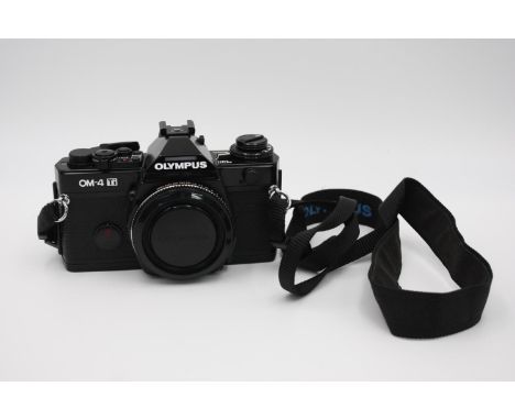 Olympus OM-4 Ti SLR Film Camera Body Only w/ Body Cap &amp; Camera Strap  The camera is WORKING &amp; in an excellent conditi