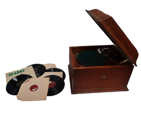 An HMV table grand gramophone - with light brown oak case, together with eight 78rpm records.