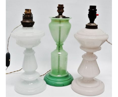 A near pair of Victorian glass lamps - of white opaque glass in baluster form, height 37cm, together with a similar green gla