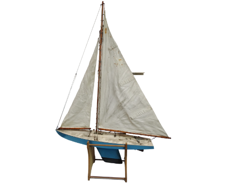 A mid 20th century pond yacht - Bermuda rig with a light blue hull and cream deck, together with a wooden stand, length 70cm.