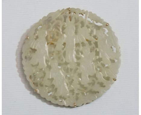 An early 20th century white jade brooch - pierced and carved decoration depicting figures amongst foliage, set in a yellow me