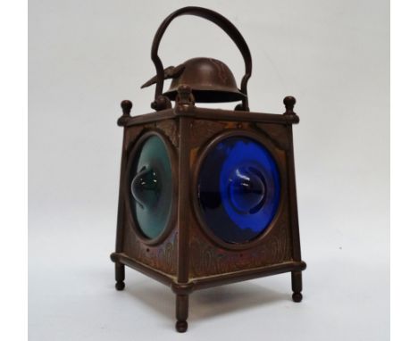 An Aesthetic Movement brass lamp - surmounted by a winged helmet with a bail handle above three coloured lenses, engraved dec