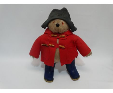Gabriel Designs Paddington Bear - blue felt hat, red coat and blue Dunlop boots, retaining original 'luggage label', height 4