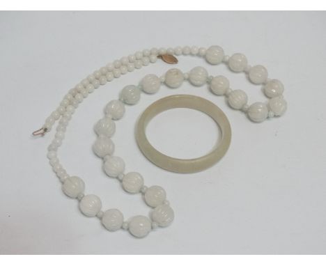 A white jade beaded necklace - with a 9ct yellow gold clasp, length 80cm, together with a jade bangle.