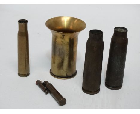 An early 20th century trench lighter - together with other brass ordnance.