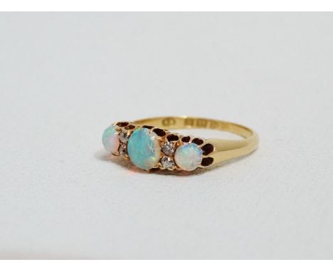 An opal and diamond dress ring - claw set in 18ct yellow gold, size M, weight 3.5g. 