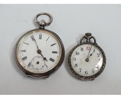 A silver cased open face pocket watch - foliate engraved with a white enamel dial set out with Roman numerals, together with 