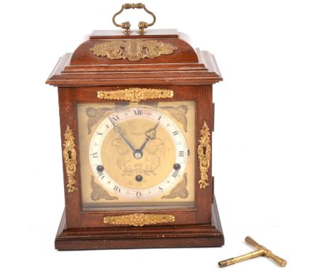 Elliott walnut mantel clock, the case with moulded top, plinth base, 6" square brass dial with seraphim spandrels, silvered c