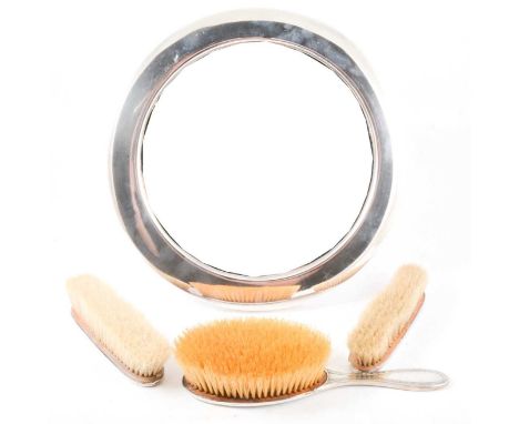 Silver plated dressing table mirror, circular , easel back, diameter 32cm, and three silver mounted hand brushes with key bor