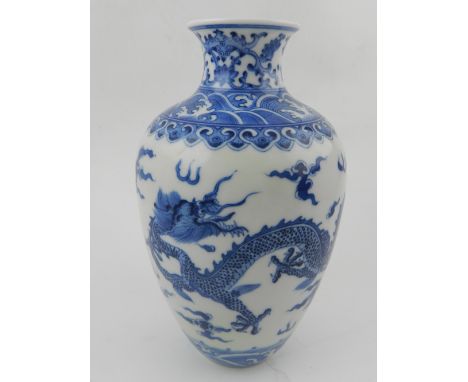 A Chinese hard paste porcelain blue and white baluster vase, decorated with dragons chasing pearls, bears seal mark to base. 