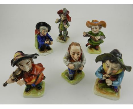 A set of six Dresden porcelain comical figural studies of dwarfs playing various musical instruments etc.