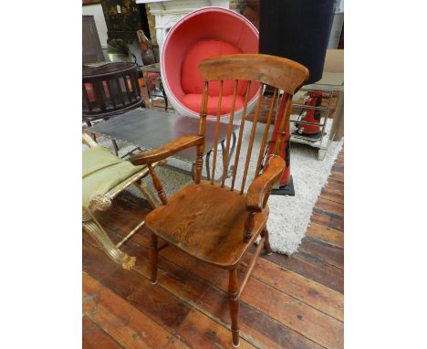 A 19th century Windsor style stained pine stick-back armchair. 
