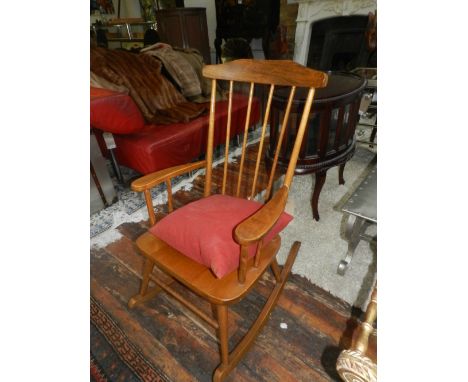 A Windsor style elm stick back rocking chair. 