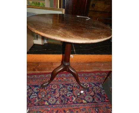 A late George III mahogany tilt-top tea table, the circular top raised on a tapered column support, tripod base. H.70cm D.63c