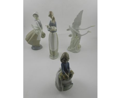 Two Lladro figural studies, together with a Nao study of herons and a Nao figural study. (4)
