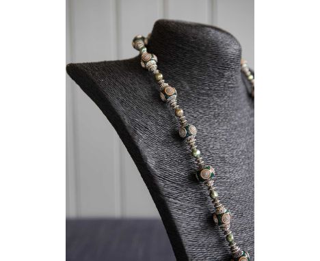 Imogen Sheeran: Freshwater Pearl Necklace
An exquisite green and olive necklace combining handmade Kashmiri metal and pine gr