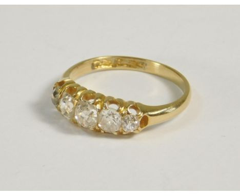 DIAMOND RING. A yellow metal ring set a row of five old cut graduated diamonds (hallmarks scratched through). (K)