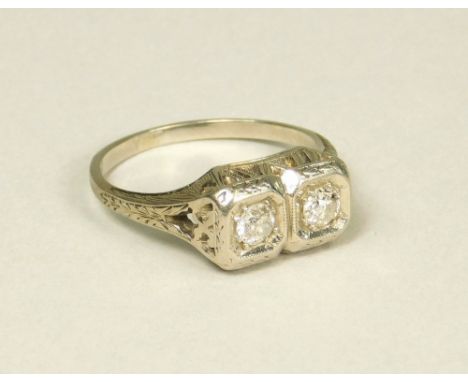 DIAMOND RING. An 18k twin stone diamond ring. (M)