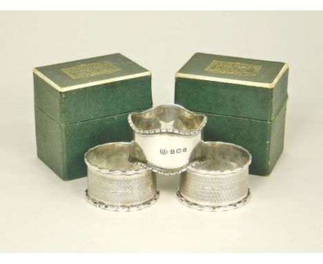 NAPKIN RINGS. A pair of engine turned napkin rings, boxed &amp; a single silver napkin ring.