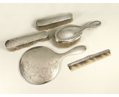 BRUSH SET ETC. A silver mounted hand mirror &amp; a pair of matching brushes. Also, a silver mounted hairbrush &amp; a dissim