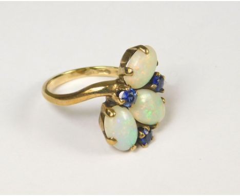 OPAL RING. A gold ring set an arrangement of three oval opals &amp; three sapphires. Stamped. (L)