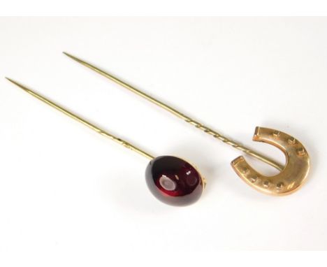 STICK PINS. A Victorian 'horseshoe' stick pin, 8.5cm. Also, a Victorian cabouchon garnet stick pin.