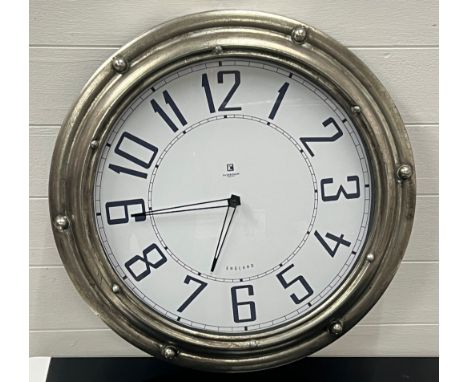 A porthole style wall clock 