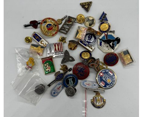A selection of collectable pins and badges to include the Moscow 1980 Olympics and Y.M.C.A