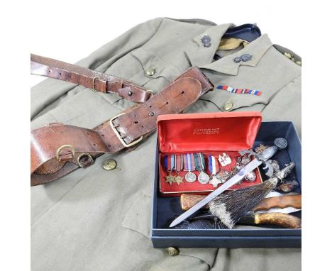 A World War II army jacket, with a leather belt, a set of miniature military dress medals and other militaria