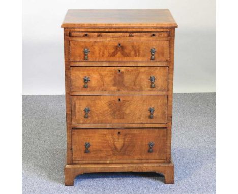 A 1920's walnut narrow chest, having a brushing slide, over three graduated drawers, on bracket feet61w x 46d x 90h cmOverall