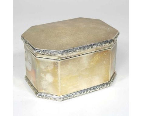An early 20th century silver tea caddy, of canted rectangular shape, with a hinged lid and tied reeded border, by Asprey, Lon