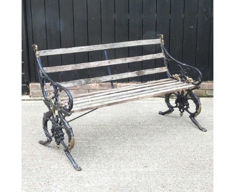 A 19th century French garden bench, by Cie &amp; Co, with gilt painted ends in the form of mythical beasts, and a slatted woo